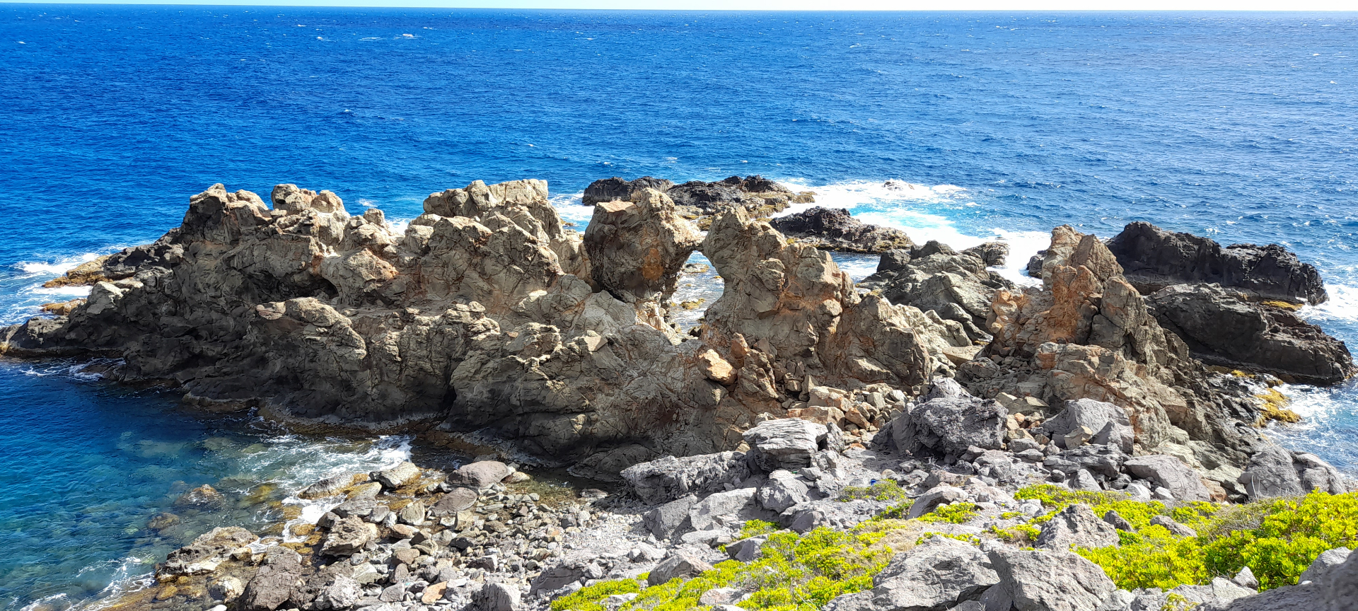 Sea-carved rock arch and turquoise Atlantic at Hell's Gate, Montserrat